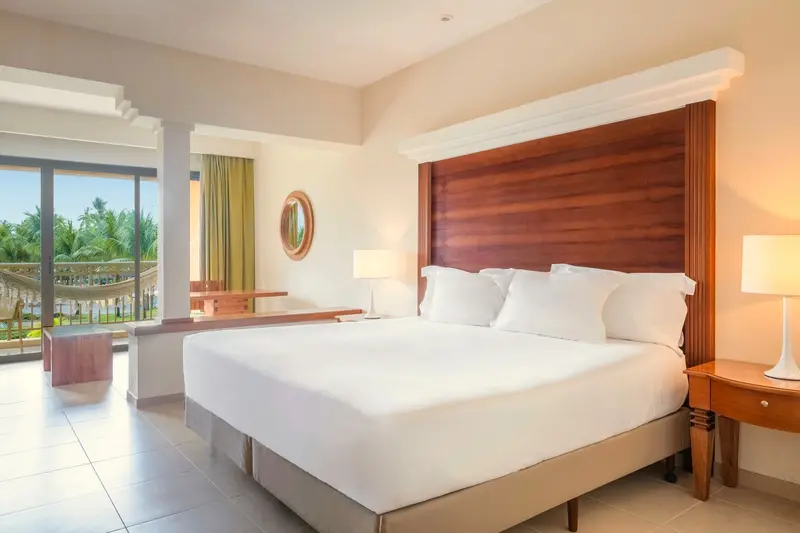 Cama king da Junior Suite Superior com saída para a varanda